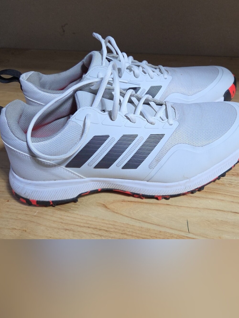 adidas White Golf Shoes with Black Stripes and Orange Accents